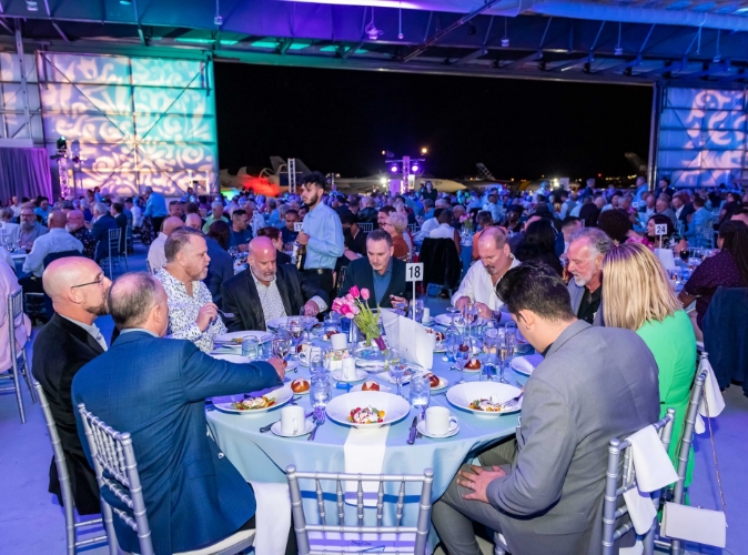 group of people attending a fancy event sitting at round table