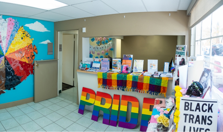 pride rainbow decorations scattered on a front desk in an office