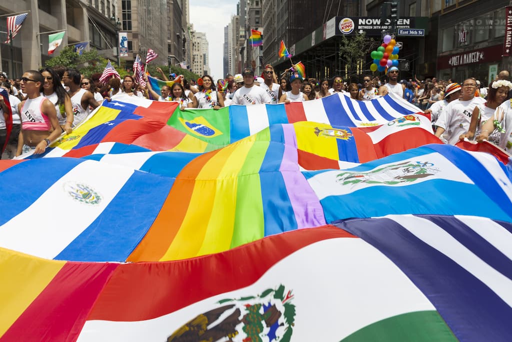 Crowds of people carrying flags at the Latinx flag parade